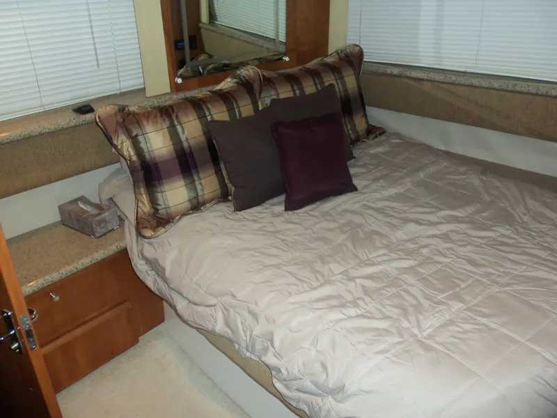 Slide: The Image of Interior of 2001 Carver 356 Motor Yacht bedroom with cozy bedding and pillows. - 28