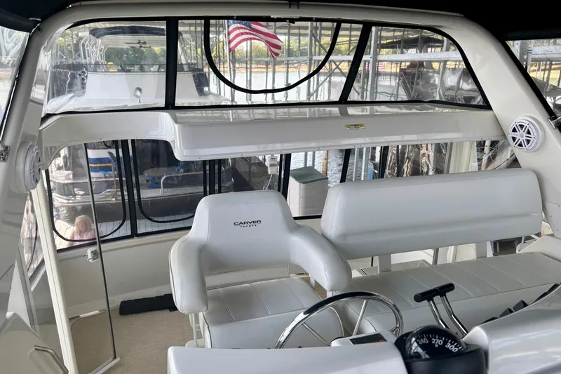 Slide: The Image of Interior of 2001 Carver 356 Motor Yacht with white seating and steering wheel. - 37