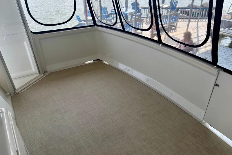 Slide: The Image of 2001 Carver 356 Motor Yacht interior with carpeted floor and large windows overlooking water. - 41