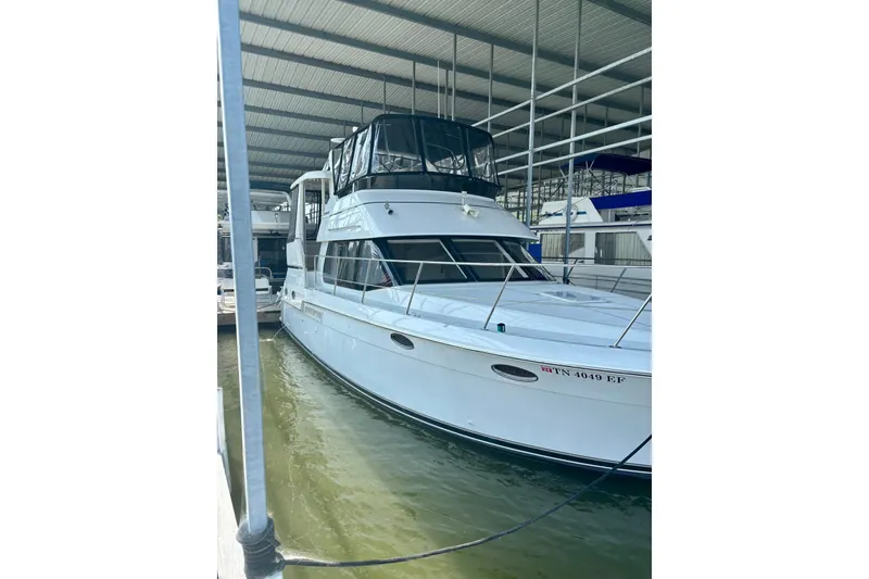 Slide: The Image of 2001 Carver 356 Motor Yacht docked in a covered marina. - 44
