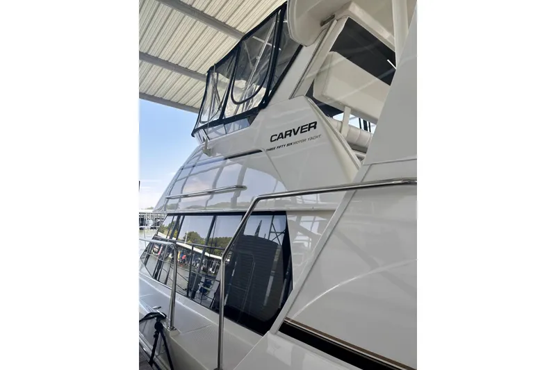Slide: The Image of 2001 Carver 356 Motor Yacht with sleek design under a covered dock. - 47