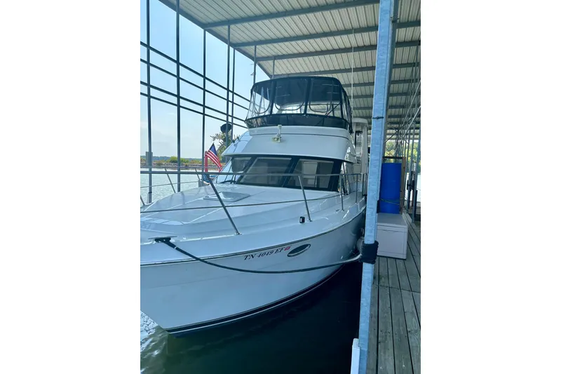 Slide: The Image of 2001 Carver 356 Motor Yacht docked in a covered marina. - 48