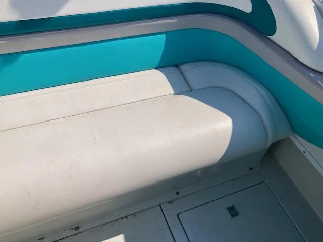 Slide: The Image of 1996 Baja 320 boat interior with teal and white seating. - 5