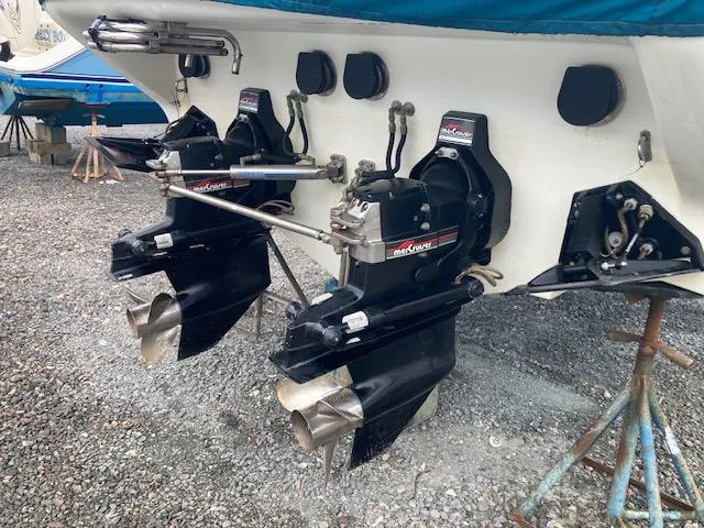 Slide: The Image of 1996 Baja 320 boat with dual MerCruiser outdrives on gravel. - 6