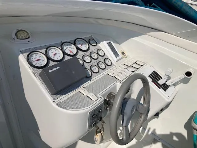 Slide: The Image of Dashboard of a 1996 Baja 320 boat with gauges and steering wheel. - 7