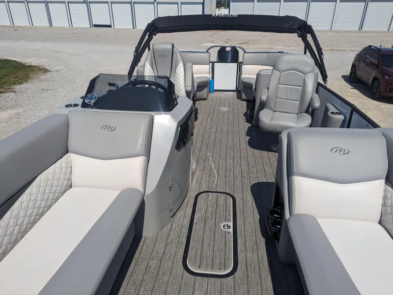 Slide: The Image of 2022 Manitou Encore 25 RF pontoon boat interior with plush seating and modern design. - 11