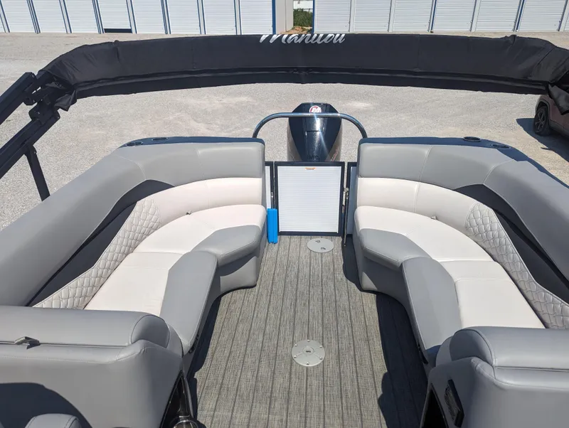 Slide: The Image of 2022 Manitou Encore 25 RF boat interior with gray seating and modern design. - 13