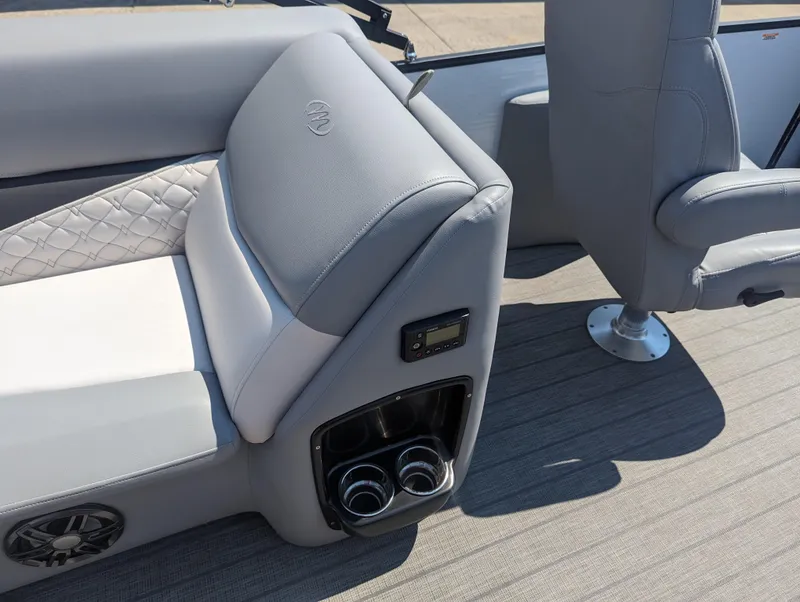 Slide: The Image of 2022 Manitou Encore 25 RF boat interior with gray seating and cup holders. - 16