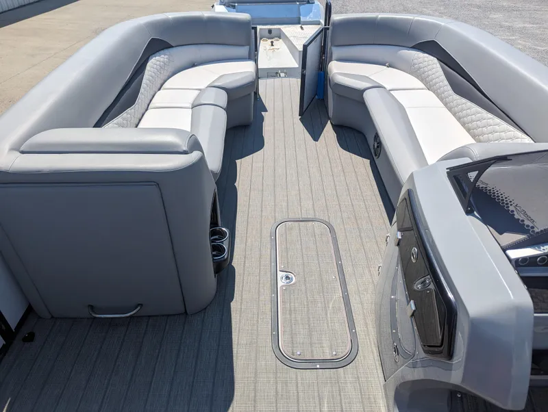 Slide: The Image of 2022 Manitou Encore 25 RF pontoon boat interior with spacious seating and modern design. - 21