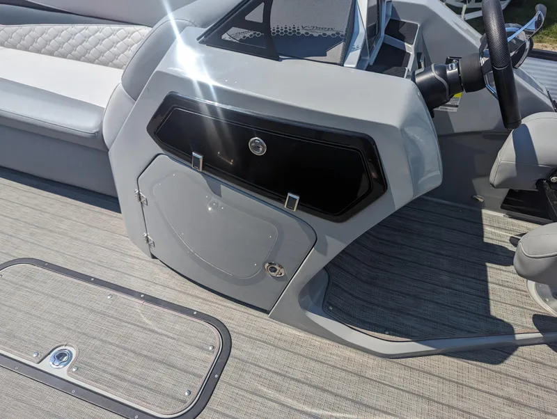 Slide: The Image of 2022 Manitou Encore 25 RF boat interior with sleek console and seating. - 22