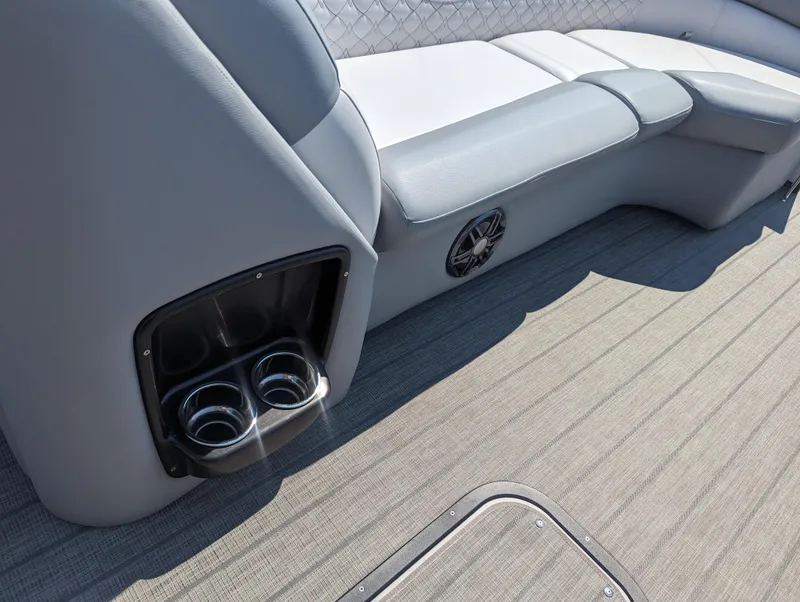 Slide: The Image of 2022 Manitou Encore 25 RF boat interior with gray seating and cup holders. - 24