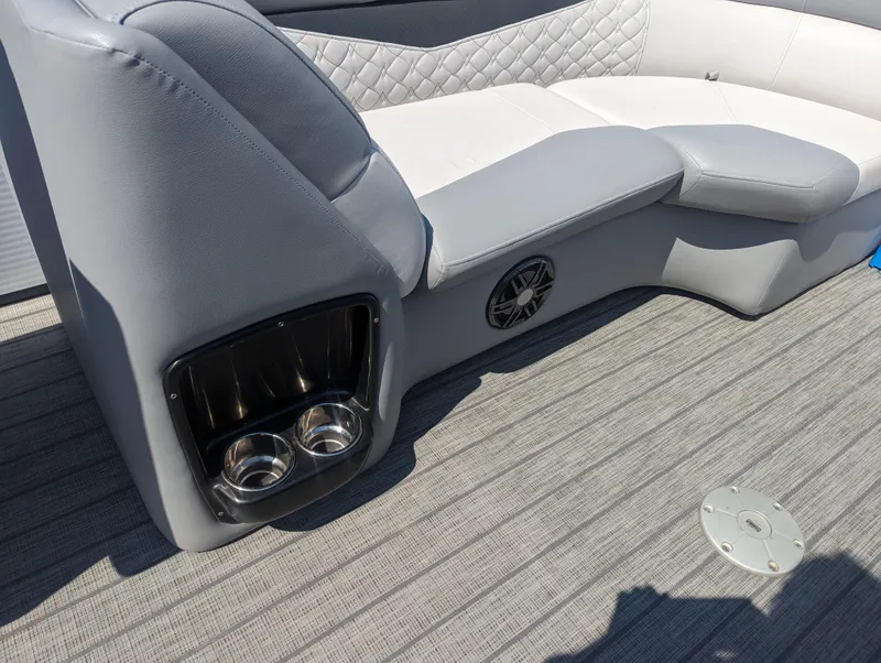 Slide: The Image of 2022 Manitou Encore 25 RF boat interior with gray seating and cup holders. - 27