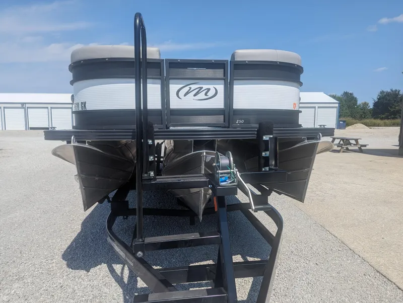 Slide: The Image of 2022 Manitou Encore 25 RF pontoon boat on trailer in sunny outdoor setting. - 3