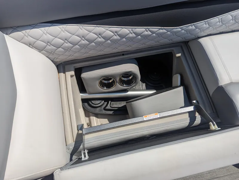 Slide: The Image of 2022 Manitou Encore 25 RF boat interior storage with cup holders and quilted upholstery. - 30