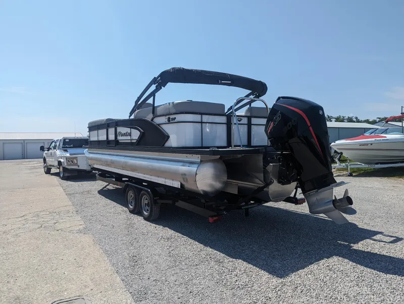 Slide: The Image of 2022 Manitou Encore 25 RF pontoon boat on trailer, parked outdoors. - 8