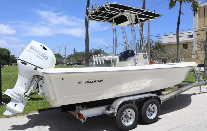 Slide: The Image of 2025 Bulls Bay 2200 boat on trailer with Suzuki outboard motor. - 0