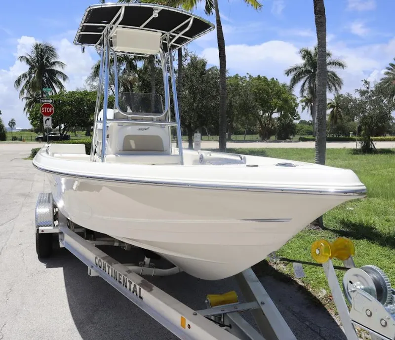 Slide: The Image of 2025 Bulls Bay 2200 boat on trailer, parked near palm trees. - 2