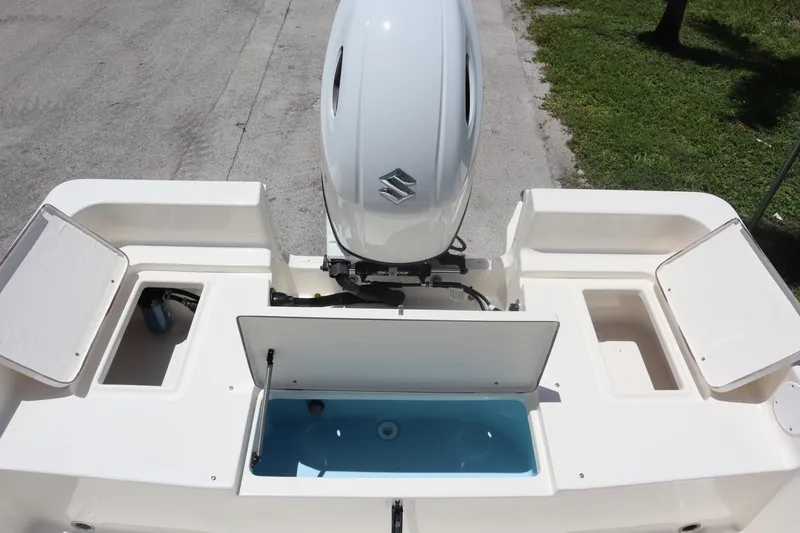 Slide: The Image of 2025 Bulls Bay 2200 boat with Suzuki outboard motor and open storage compartments. - 9