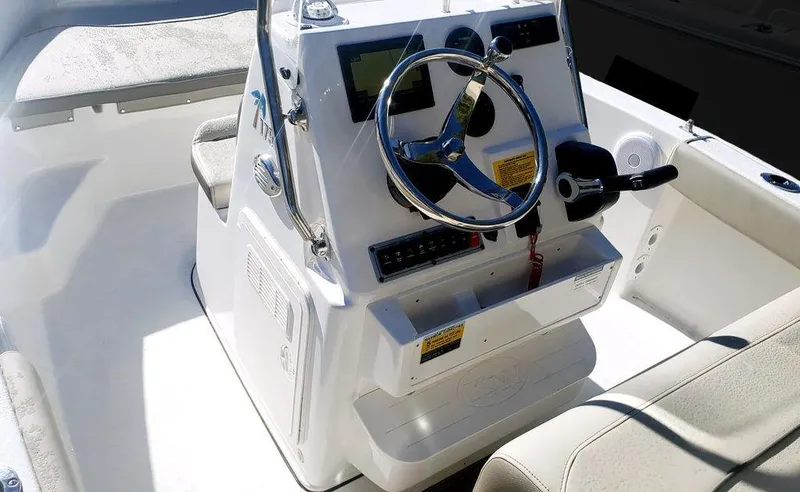 Slide: The Image of 2025 Key West 239 FS boat console with steering wheel and controls. - 10