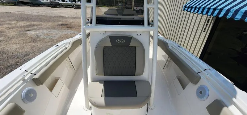 Slide: The Image of 2025 Key West 239 FS boat interior with cushioned seating and storage compartments. - 15