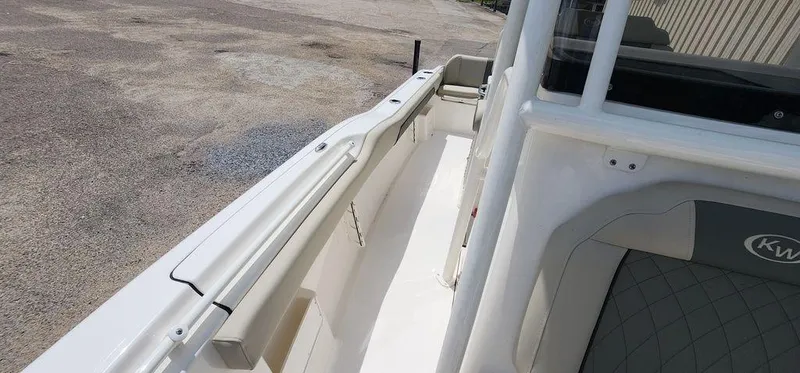 Slide: The Image of 2025 Key West 239 FS boat interior with sleek white design and comfortable seating. - 18