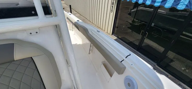 Slide: The Image of 2025 Key West 239 FS boat interior with cushioned seating and sleek design. - 19