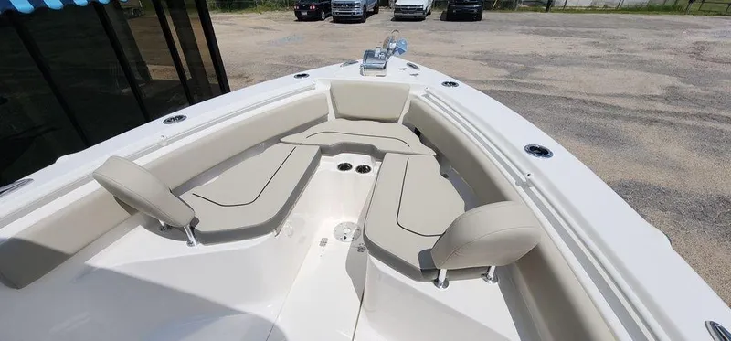 Slide: The Image of 2025 Key West 239 FS boat interior with beige seating and cup holders. - 20