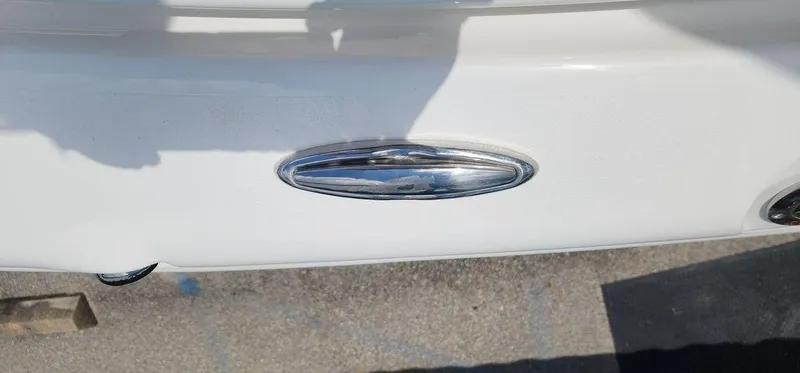 Slide: The Image of 2025 Key West 239 FS boat detail with chrome accent on white surface. - 32