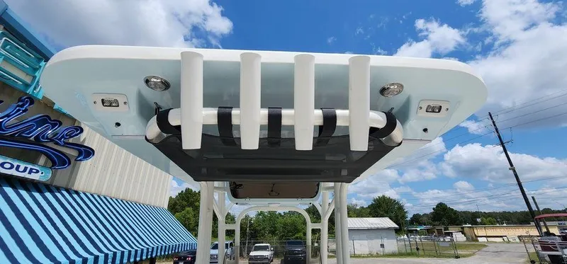 Slide: The Image of 2025 Key West 239 FS boat top view with rod holders and blue sky background. - 37