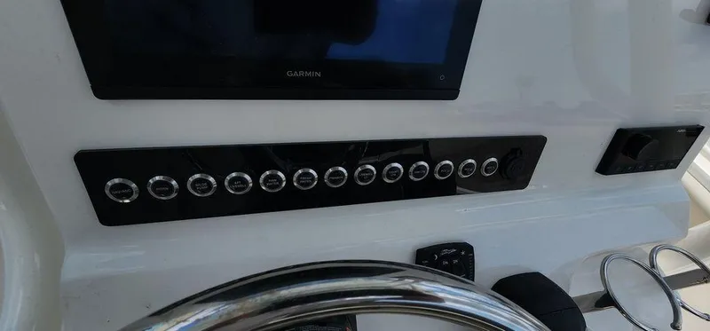 Slide: The Image of 2025 Key West 239 FS boat dashboard with Garmin display and control panel. - 40