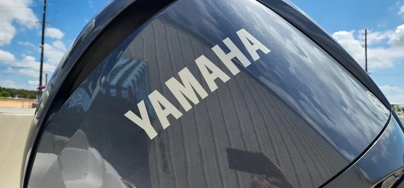 Slide: The Image of Yamaha engine on 2025 Key West 239 FS boat under a clear blue sky. - 41