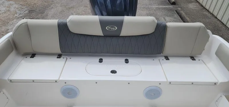 Slide: The Image of 2025 Key West 239 FS boat seating area with storage compartments and speakers. - 44
