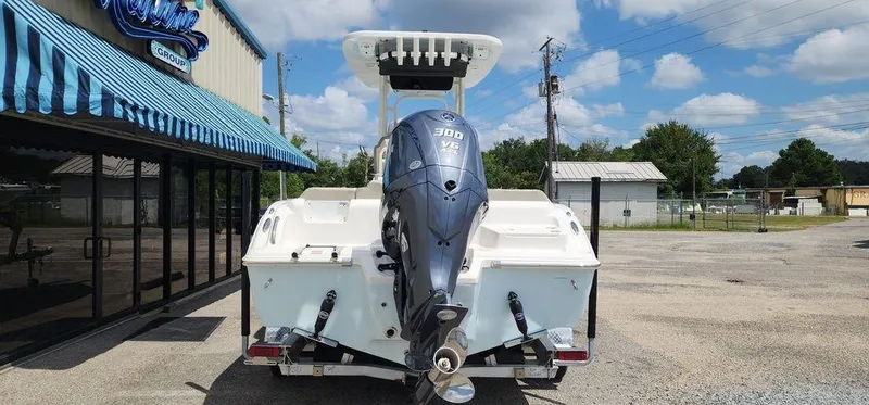 Slide: The Image of 2025 Key West 239 FS boat with powerful outboard motor, parked outside a dealership. - 5