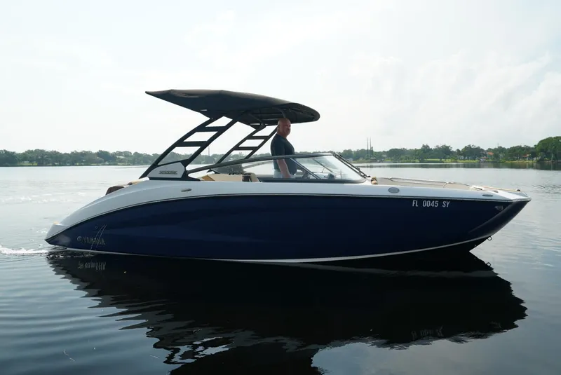 Slide: The Image of 2021 Yamaha Boats 252SE cruising on a calm lake. - 0