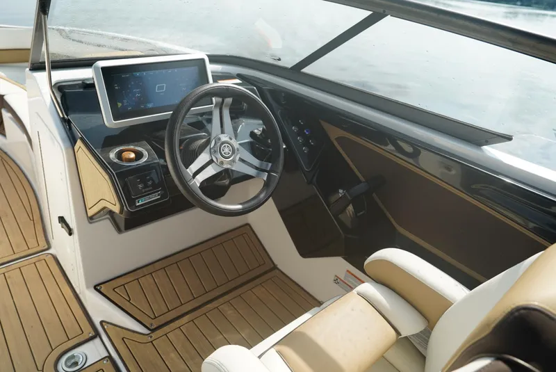 Slide: The Image of 2021 Yamaha Boats 252SE cockpit with modern steering and dashboard design. - 10