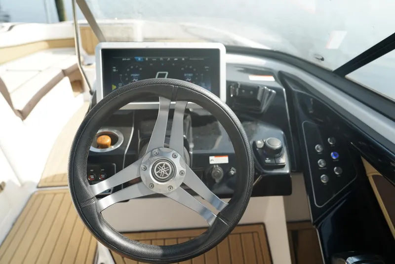 Slide: The Image of 2021 Yamaha Boats 252SE steering wheel and dashboard interior. - 12