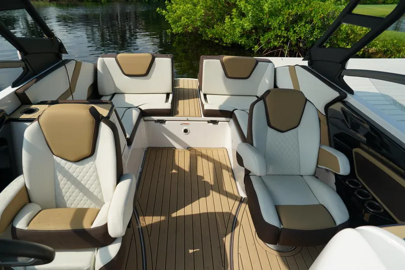 Slide: The Image of Luxurious interior of 2021 Yamaha Boats 252SE with elegant seating and wood-style flooring. - 19