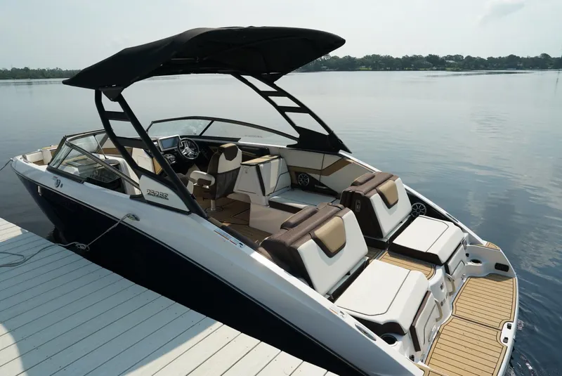 Slide: The Image of 2021 Yamaha Boats 252SE on calm water, featuring sleek design and spacious seating. - 6