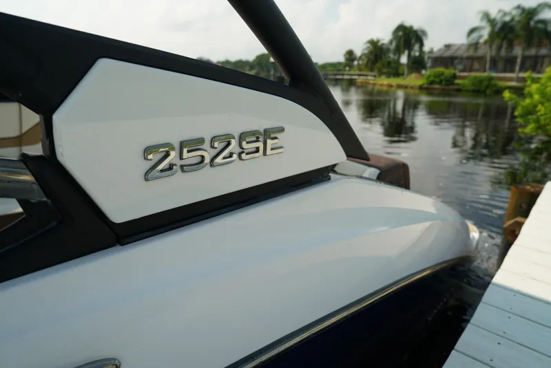 Slide: The Image of Yamaha Boats 2021 252SE docked by a serene waterfront. - 9