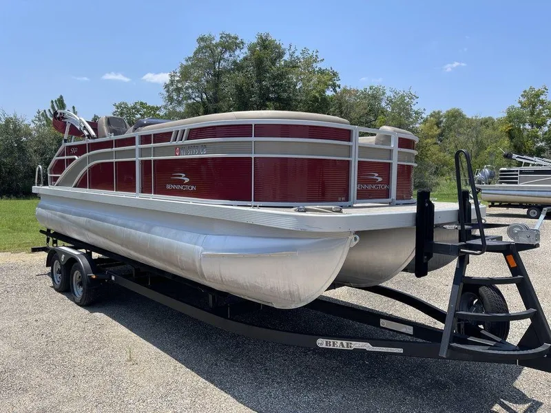 Slide: The Image of 2021 Bennington 22 SSBX pontoon boat on trailer, parked outdoors. - 1