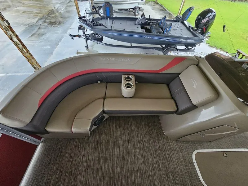 Slide: The Image of 2021 Bennington 22 SSBX pontoon boat interior with seating and cup holders. - 13