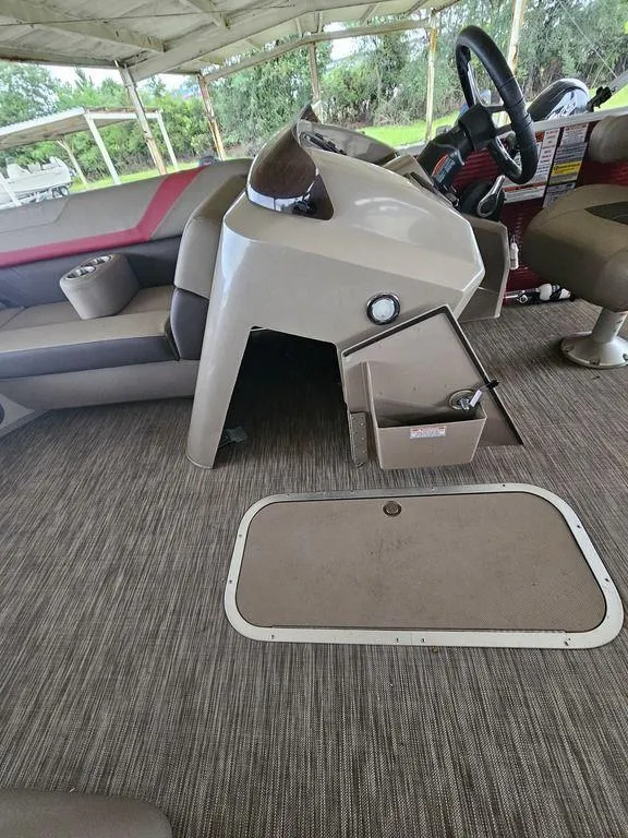 Slide: The Image of 2021 Bennington 22 SSBX boat interior with steering console and seating area. - 16