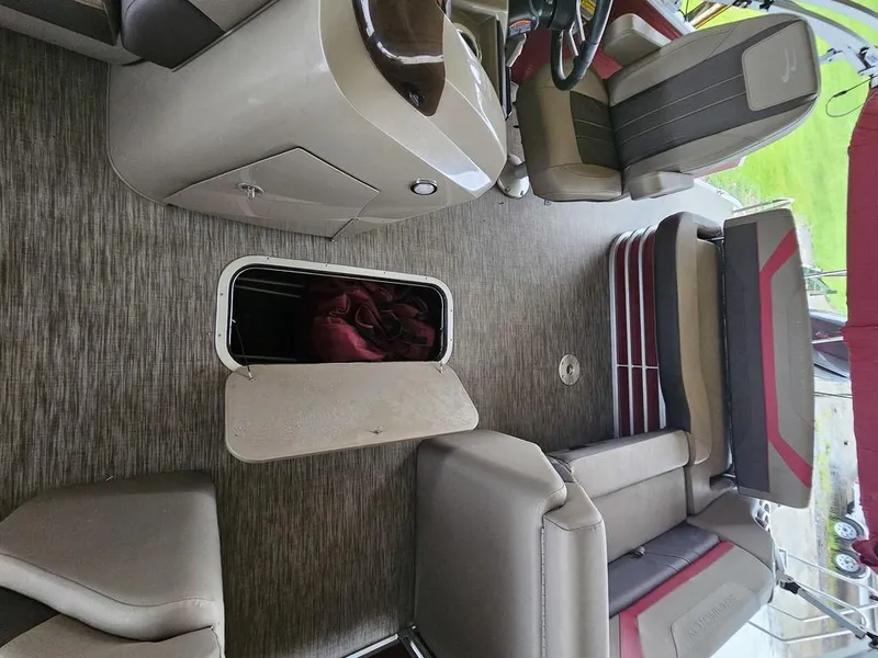 Slide: The Image of 2021 Bennington 22 SSBX boat interior with open storage compartment and seating. - 17