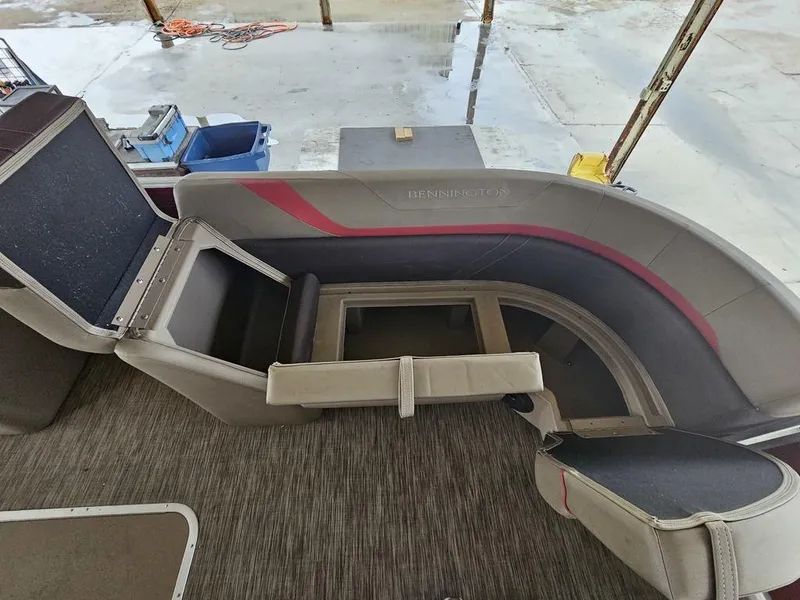 Slide: The Image of 2021 Bennington 22 SSBX pontoon boat interior with seating and storage compartments. - 18