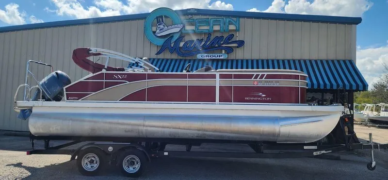 Slide: The Image of 2021 Bennington 22 SSBX pontoon boat on trailer outside Ocean Marine Group. - 2