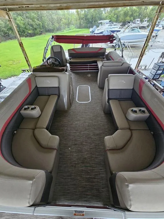 Slide: The Image of 2021 Bennington 22 SSBX pontoon boat interior with spacious seating and cup holders. - 23