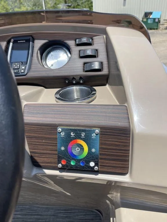 Slide: The Image of 2021 Bennington 22 SSBX boat dashboard with controls and color wheel panel. - 24