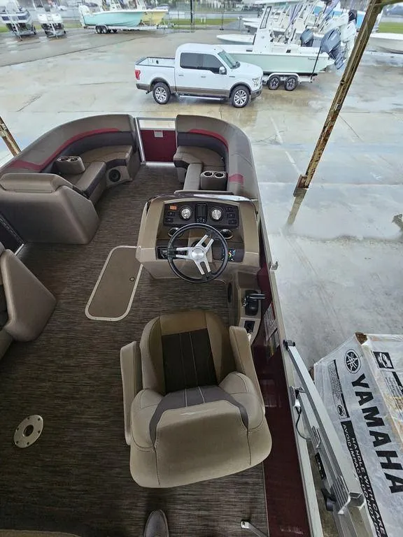 Slide: The Image of 2021 Bennington 22 SSBX pontoon boat interior with Yamaha engine box nearby. - 26
