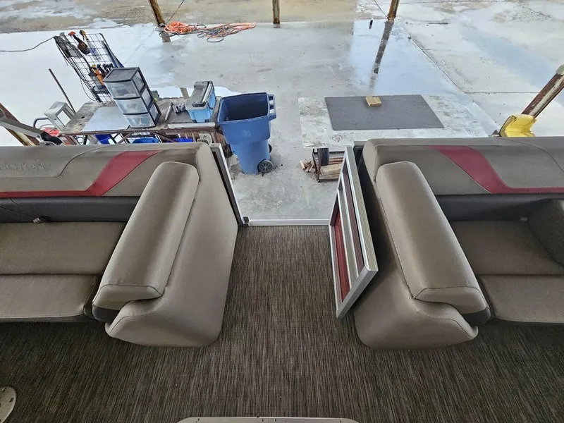 Slide: The Image of 2021 Bennington 22 SSBX boat interior with beige seating and red accents. - 27