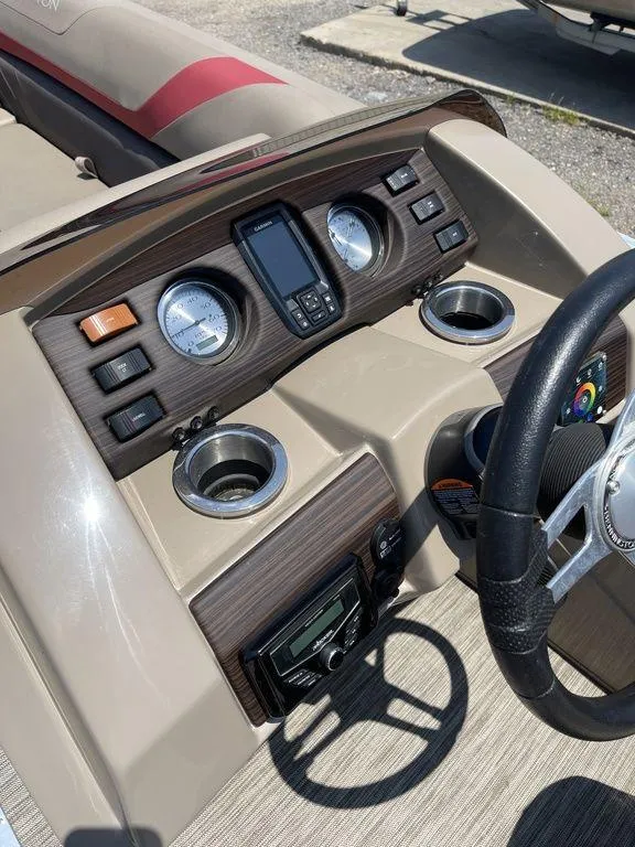 Slide: The Image of 2021 Bennington 22 SSBX boat dashboard with gauges and steering wheel. - 28